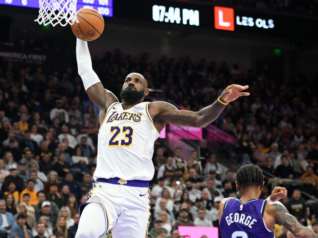 SALT LAKE CITY, UTAH - NOVEMBER 23: LeBron James #23 of the Los Angeles Lakers dunks in front of Keyonte George #3 of the Utah Jazz during the second half of a game at Delta Center on November 23, 2025 in Salt Lake City, Utah.