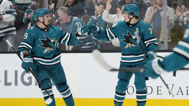 SAN JOSE, CALIFORNIA - NOVEMBER 23: Macklin Celebrini #71 of the San Jose Sharks is congratulated by Dmitry Orlov #9 after Celebrini scored a goal against the Boston Bruins in the second period at SAP Center on November 23, 2025 in San Jose, California.
