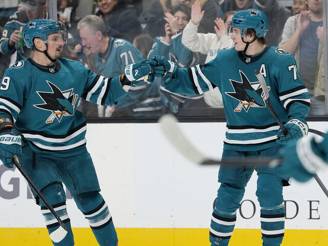 SAN JOSE, CALIFORNIA - NOVEMBER 23: Macklin Celebrini #71 of the San Jose Sharks is congratulated by Dmitry Orlov #9 after Celebrini scored a goal against the Boston Bruins in the second period at SAP Center on November 23, 2025 in San Jose, California.