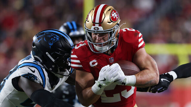 SANTA CLARA, CALIFORNIA - NOVEMBER 24: Christian McCaffrey #23 of the San Francisco 49ers is tackled by Claudin Cherelus #53 of the Carolina Panthers in the first quarter of the game at Levi's Stadium on November 24, 2025 in Santa Clara, California.