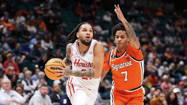 LAS VEGAS, NEVADA - NOVEMBER 24: Emanuel Sharp #21 of the Houston Cougars goes to the basket against Kiyan Anthony #7 of the Syracuse Orange during the second half of the Players Era Basketball Championship at Grand Garden Arena on November 24, 2025 in Las Vegas, Nevada.