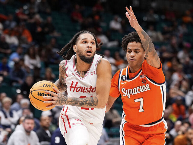 LAS VEGAS, NEVADA - NOVEMBER 24: Emanuel Sharp #21 of the Houston Cougars goes to the basket against Kiyan Anthony #7 of the Syracuse Orange during the second half of the Players Era Basketball Championship at Grand Garden Arena on November 24, 2025 in Las Vegas, Nevada.