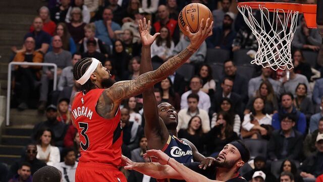 TORONTO, ON- NOVEMBER 24 - forward Brandon Ingram (3) of the Toronto Raptors lays up a shot over forward Chris Livingston (8) of the Cleveland Cavaliers of the Cleveland Cavaliers and forward Larry Nance Jr. (22) of the Cleveland Cavaliers as the Toronto Raptors play the Cleveland Cavaliers at Scotiabank Arena in Toronto. November 24, 2025. Steve Russell/Toronto Star (Steve Russell/Toronto Star via Getty Images)
