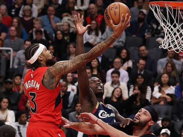 TORONTO, ON- NOVEMBER 24 - forward Brandon Ingram (3) of the Toronto Raptors lays up a shot over forward Chris Livingston (8) of the Cleveland Cavaliers of the Cleveland Cavaliers and forward Larry Nance Jr. (22) of the Cleveland Cavaliers as the Toronto Raptors play the Cleveland Cavaliers at Scotiabank Arena in Toronto. November 24, 2025. Steve Russell/Toronto Star (Steve Russell/Toronto Star via Getty Images)