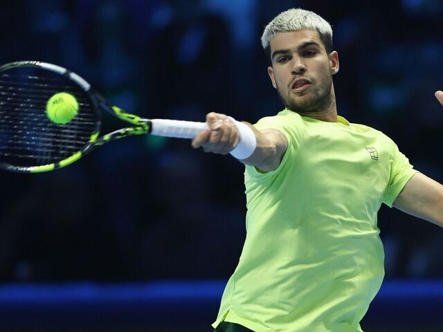 Carlos Alcaraz returns a shot during the men's singles final match between Jannik Sinner of Italy and Carlos Alcaraz of Spain at the ATP Finals tennis tournament in Turin, Italy, on Nov. 16, 2025.