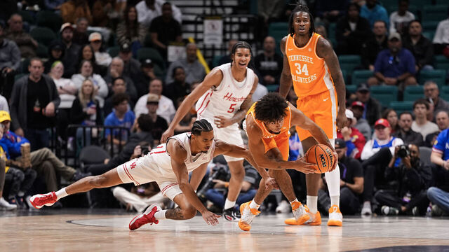 LAS VEGAS, NEVADA - NOVEMBER 25: Ja’Kobi Gillespie #0 of the Tennessee Volunteers and Milos Uzan #7 of the Houston Cougars battle for a loose ball in the first half during the Players Era Championship basketball tournament at Grand Garden Arena on November 25, 2025 in Las Vegas, Nevada.
