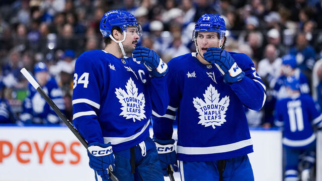 TORONTO, CANADA - NOVEMBER 8: Auston Matthews #34 and Matthew Knies #23 of the Toronto Maple Leafs speak in a break in play against the Boston Bruins during the first period in their NHL game at Scotiabank Arena on November 8, 2025 in Toronto, Ontario, Canada.