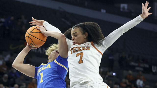 LAS VEGAS, NEVADA - NOVEMBER 26: Jordan Lee #7 of the Texas Longhorns fouls Kiki Rice #1 of the UCLA Bruins during the third quarter of a Players Era Championship basketball tournament game at Michelob ULTRA Arena on November 26, 2025 in Las Vegas, Nevada.