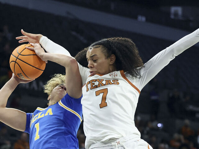 LAS VEGAS, NEVADA - NOVEMBER 26: Jordan Lee #7 of the Texas Longhorns fouls Kiki Rice #1 of the UCLA Bruins during the third quarter of a Players Era Championship basketball tournament game at Michelob ULTRA Arena on November 26, 2025 in Las Vegas, Nevada.