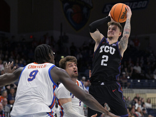 SAN DIEGO, CALIFORNIA - NOVEMBER 27: Brock Harding #2 of the TCU Horned Frogs shoots the ball while defended by Urban Klavzar #7 and Rueben Chinyelu #9 of the Florida Gators during the second half in the 2025 Rady Children's Invitational at Jenny Craig Pavilion on November 27, 2025 in San Diego, California.