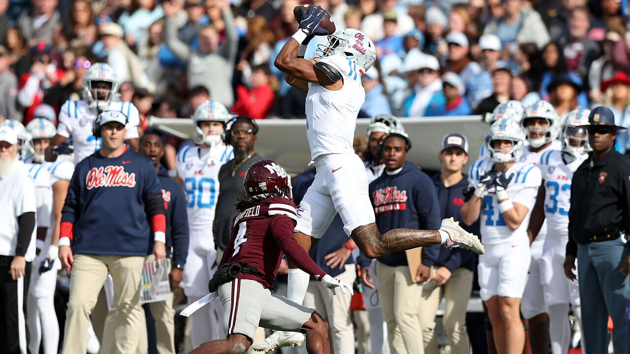 STARKVILLE, MISSISSIPPI - NOVEMBER 28: De'Zhaun Stribling #1 of the Mississippi Rebels catches a pass against Deago Brumfield #4 of the Mississippi State Bulldogs during the first half at Davis Wade Stadium on November 28, 2025 in Starkville, Mississippi.