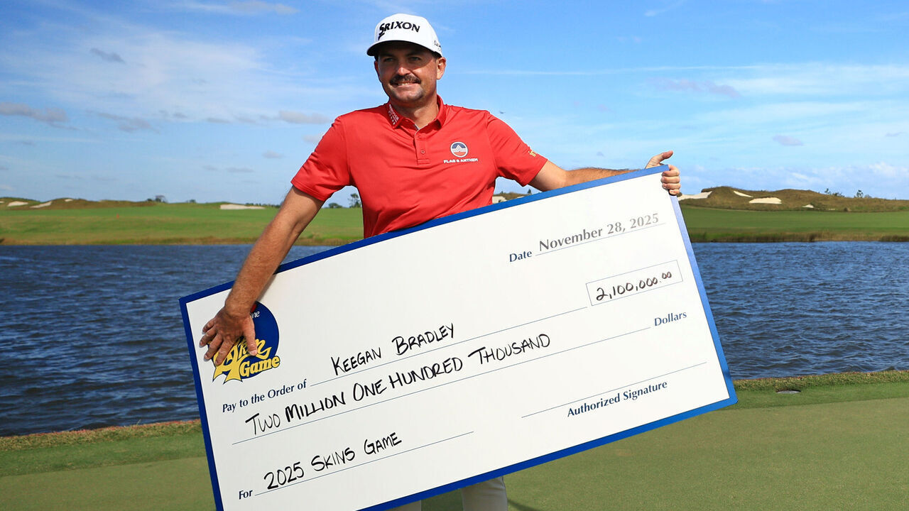 PALM BEACH GARDENS, FLORIDA - NOVEMBER 28: Keegan Bradley of the United States celebrates with his check after winning The Skins Game at Panther National on November 28, 2025 in Palm Beach Gardens, Florida.