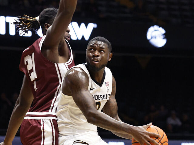 NASHVILLE, TN - NOVEMBER 12: Vanderbilt Commodores guard Duke Miles (2) makes a move around Eastern Kentucky Colonels forward Yvens Paul (21) during a game between the Vanderbilt Commodores and Eastern Kentucky Colonels, November 12, 2025, at Memorial Gymnasium in Nashville, Tennessee.