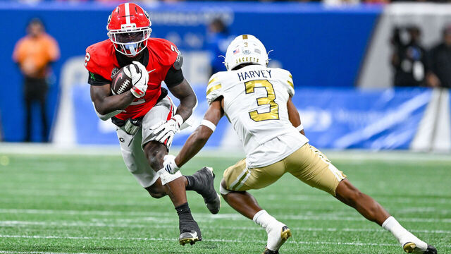 ATLANTA, GA - NOVEMBER 28: Georgia running back Josh McCray (2) runs the ball as Georgia Tech defensive back Ahmari Harvey (3) attempts a tackle during the college football game between the Georgia Bulldogs and the Georgia Tech Yellow Jackets on November 28th, 2025 at Mercedes-Benz Stadium in Atlanta, GA.