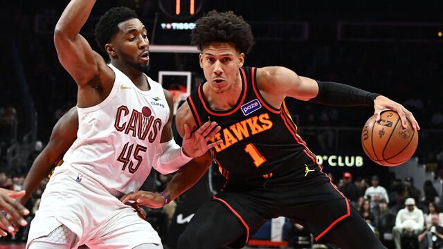 ATLANTA, GEORGIA - NOVEMBER 28: Jalen Johnson #1 of the Atlanta Hawks moves the ball against Donovan Mitchell #45 of the Cleveland Cavaliers in the first quarter during the 2025-26 Emirates NBA Cup at State Farm Arena on November 28, 2025 in Atlanta, Georgia.