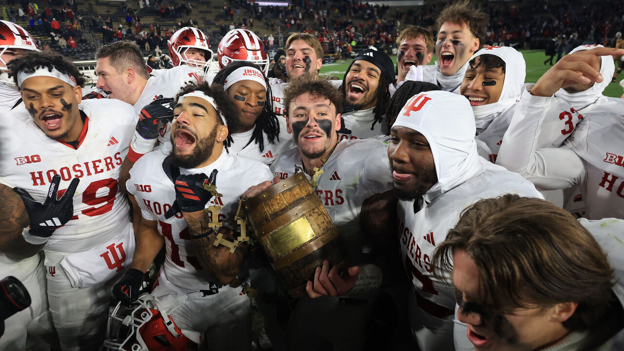 WEST LAFAYETTE, INDIANA - NOVEMBER 28: Aiden Fisher #4 of the Indiana Hoosiers holds up the Old Oaken Bucket and celebrates with teammates after a win over the Purdue Boilermakers at Ross-Ade Stadium on November 28, 2025 in West Lafayette, Indiana.