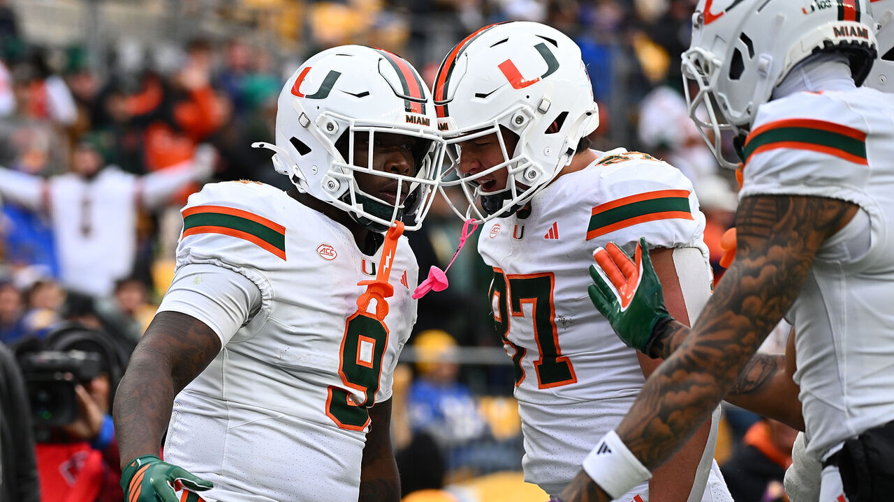PITTSBURGH, PENNSYLVANIA - NOVEMBER 29: Elija Lofton #9 of the Miami Hurricanes celebrates with teammate Alex Bauman #87 after scoring a touchdown in the second quarter during the game against the Pittsburgh Panthers at Acrisure Stadium on November 29, 2025 in Pittsburgh, Pennsylvania.