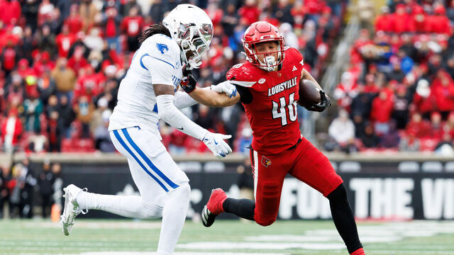 LOUISVILLE, KENTUCKY - NOVEMBER 29: Braxton Jennings #46 of the Louisville Cardinals stiff arms Cam Dooley #18 of the Kentucky Wildcats in the second half at L&N Federal Credit Union Stadium on November 29, 2025 in Louisville, Kentucky.
