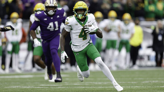 SEATTLE, WASHINGTON - NOVEMBER 29: Malik Benson #4 of the Oregon Ducks runs the ball during the second quarter of the game against the Washington Huskies at Husky Stadium on November 29, 2025 in Seattle, Washington.