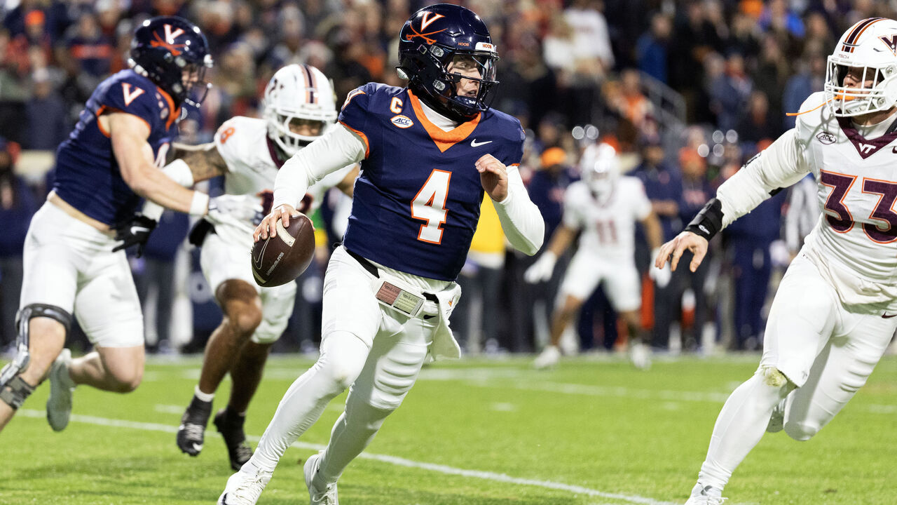 CHARLOTTESVILLE, VIRGINIA - NOVEMBER 29: Chandler Morris #4 of the Virginia Cavaliers scrambles away from Ben Bell #33 of the Virginia Tech Hokies in the first half during a game at Scott Stadium on November 29, 2025 in Charlottesville, Virginia.