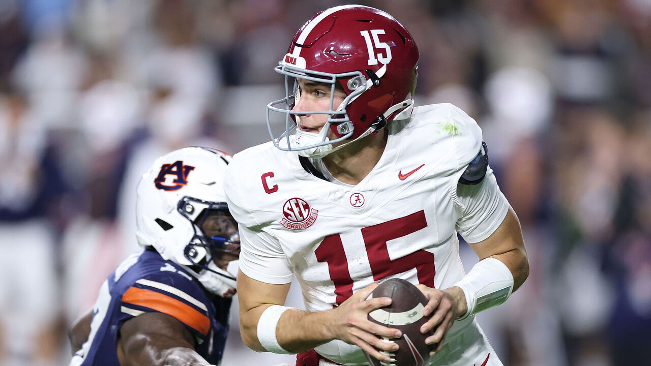 AUBURN, ALABAMA - NOVEMBER 29: Ty Simpson #15 of the Alabama Crimson Tide escapes the pressure by the Auburn Tigers during the second quarter at Jordan-Hare Stadium on November 29, 2025 in Auburn, Alabama.