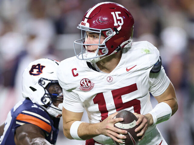 AUBURN, ALABAMA - NOVEMBER 29: Ty Simpson #15 of the Alabama Crimson Tide escapes the pressure by the Auburn Tigers during the second quarter at Jordan-Hare Stadium on November 29, 2025 in Auburn, Alabama.