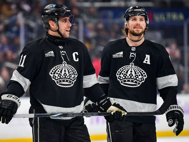 LOS ANGELES, CA - NOVEMBER 29: Anze Kopitar #11 and Adrian Kempe #9 of the Los Angeles Kings look on during the first period against the Vancouver Canucks at Crypto.com Arena on November 29, 2025 in Los Angeles, California.
