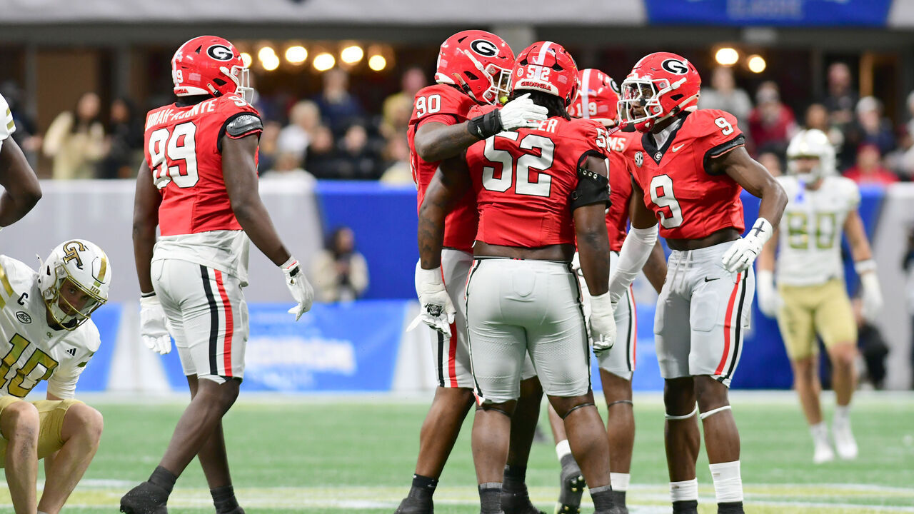 ATLANTA, GEORGIA - NOVEMBER 28: Christen Miller #52 of the Georgia Bulldogs is congratulated on his sack by defensive teammates during the first quarter of the 2025 Invesco QQQ Atlanta Gridiron Classic between the Georgia Bulldogs and the Georgia Tech Yellow Jackets on November 28, 2025 in Atlanta, Georgia.
