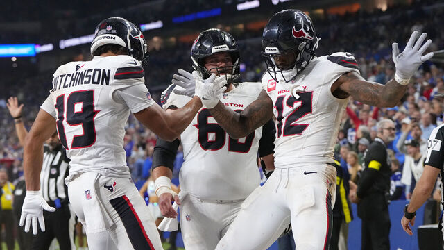 INDIANAPOLIS, INDIANA - NOVEMBER 30: Nico Collins #12 of the Houston Texans celebrates with Xavier Hutchinson #19 after his rushing touchdown against the Indianapolis Colts during the fourth quarter at Lucas Oil Stadium on November 30, 2025 in Indianapolis, Indiana.
