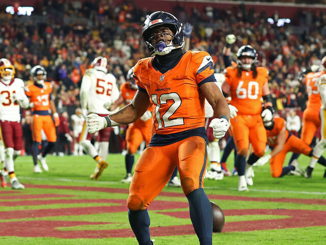 LANDOVER, MARYLAND - NOVEMBER 30: RJ Harvey #12 of the Denver Broncos scores a rushing touchdown against the Washington Commanders during overtime at Northwest Stadium on November 30, 2025 in Landover, Maryland.