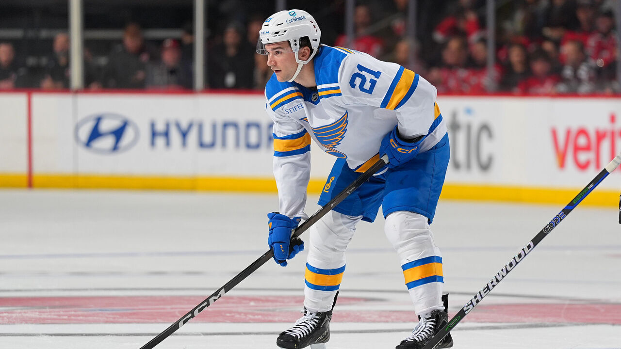 NEWARK, NJ - NOVEMBER 26: Jimmy Snuggerud #21 of the St. Louis Blues during a face off during the game against the New Jersey Devils on November 26, 2025 at the Prudential Center in Newark, New Jersey.