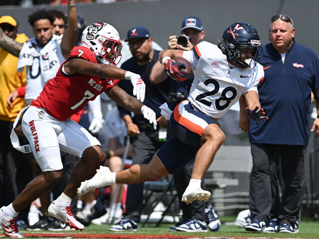 RALEIGH, NC - SEPTEMBER 06: Cornerback Brian Nelson II #7 of the NC State Wolfpack pushes Running Back Noah Vaughn #28 of the Virginia Cavaliers out of bounds during the College Football game between the NC State Wolfpack and the Virginia Cavaliers on September 6, 2025 at Carter-Finley Stadium in Raleigh, North Carolina.