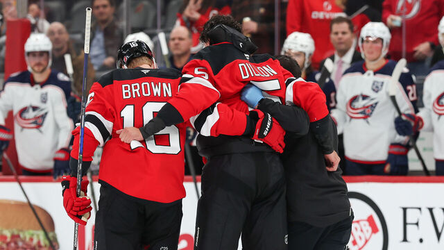 NEWARK, NJ - DECEMBER 01: Brenden Dillon #5 of the New Jersey Devils is helped off the ice after a fight during a game between the Columbus Blue Jackets and New Jersey Devils at Prudential Center on December 1, 2025 in Newark, New Jersey.