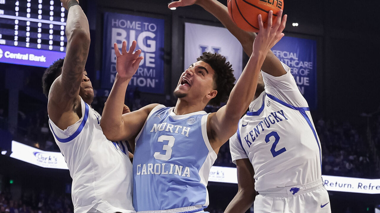 LEXINGTON, KENTUCKY - DECEMBER 2: Derek Dixon #3 of the North Carolina Tar Heels goes up for a shot against Brandon Garrison #10 and Jasper Johnson #2 of the Kentucky Wildcats during the first half at Rupp Arena on December 2, 2025 in Lexington, Kentucky.