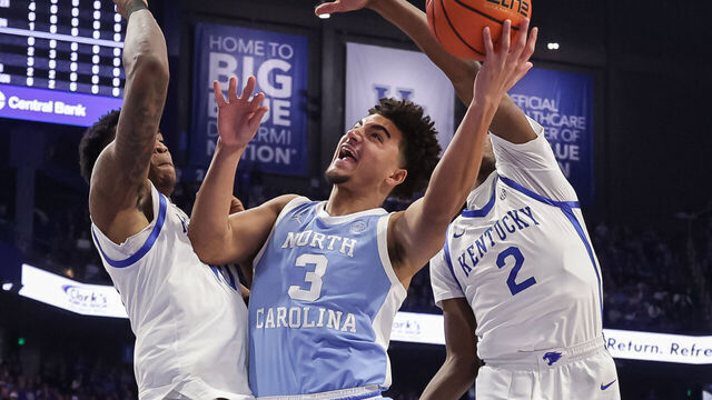 LEXINGTON, KENTUCKY - DECEMBER 2: Derek Dixon #3 of the North Carolina Tar Heels goes up for a shot against Brandon Garrison #10 and Jasper Johnson #2 of the Kentucky Wildcats during the first half at Rupp Arena on December 2, 2025 in Lexington, Kentucky.