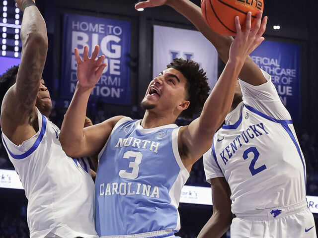 LEXINGTON, KENTUCKY - DECEMBER 2: Derek Dixon #3 of the North Carolina Tar Heels goes up for a shot against Brandon Garrison #10 and Jasper Johnson #2 of the Kentucky Wildcats during the first half at Rupp Arena on December 2, 2025 in Lexington, Kentucky.