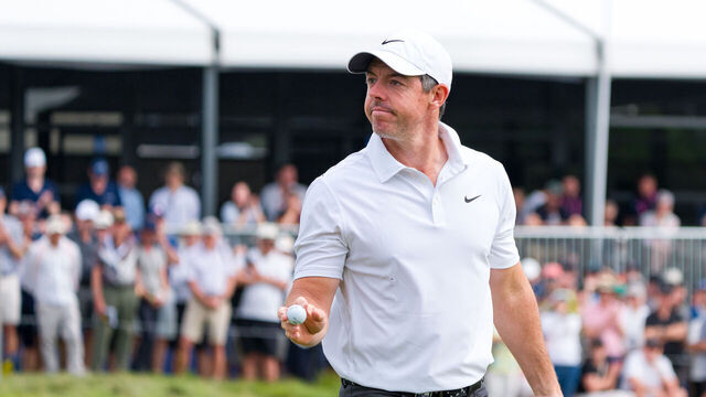 MELBOURNE, AUSTRALIA - DECEMBER 04: Rory McIlroy (R) of Northern Ireland lacknowledges the crowd on the 18th green on day one of the Crown Australian Open 2025 at The Royal Melbourne Golf Club on December 04, 2025 in Melbourne, Australia.