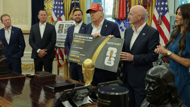 WASHINGTON, DC - AUGUST 22: FIFA President Gianni Infantino and U.S. President Donald Trump hold a large World Cup ticket replica in the Oval Office as Vice President JD Vance (3rd-L) and Homeland Security Director Kristi Noem look on August 22, 2025 in Washington, DC. Trump announced the FIFA World Cup 2026 draw will take place at The Kennedy Center.