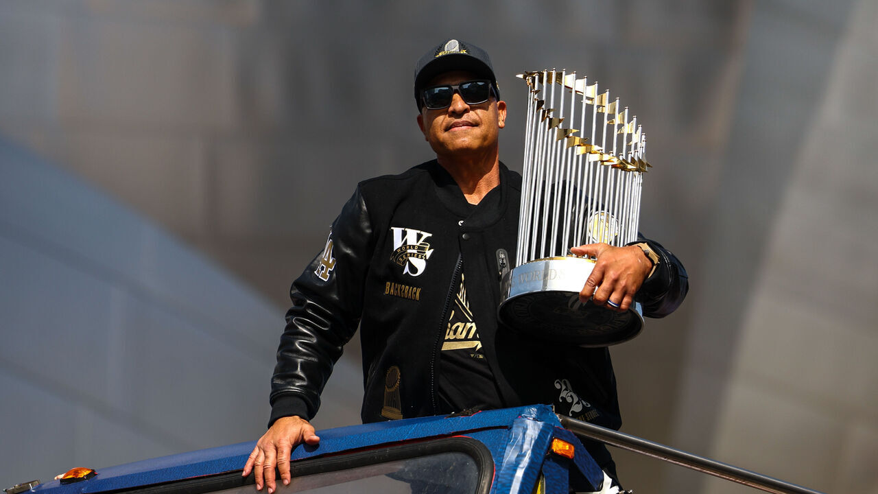 LOS ANGELES, CA - NOVEMBER 03: Manager Dave Roberts holds the Commissioner's Trophy in front of Walt Disney Concert Hall during the Los Angeles Dodgers World Series Championship parade on Monday, November 3, 2025 in Los Angeles, California.