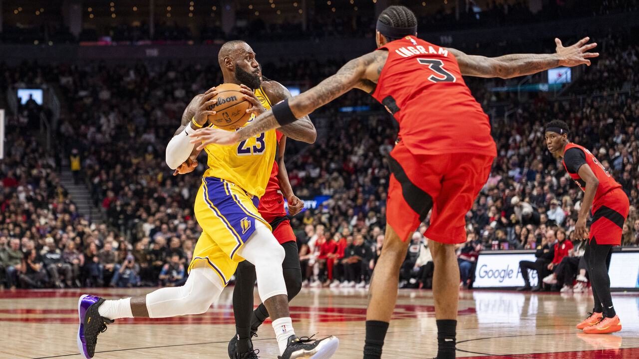 TORONTO, ON - DECEMBER 4: LeBron James #23 of the Los Angeles Lakers goes to the basket as Brandon Ingram #3 of the Toronto Raptors defends during first half action at Scotiabank Arena on December 4, 2025 in Toronto, Ontario, Canada. NOTE TO USER: User expressly acknowledges and agrees that, by downloading and/or using this Photograph, user is consenting to the terms and conditions of the Getty Images License Agreement.