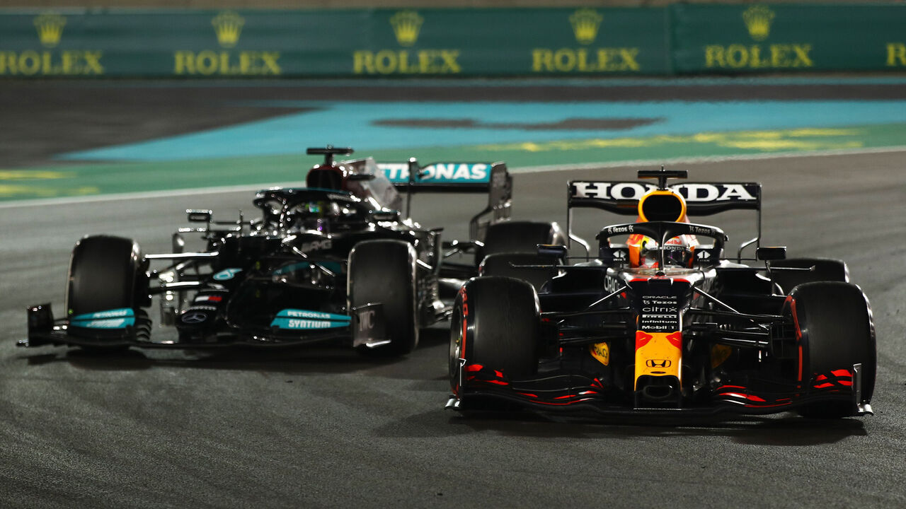 ABU DHABI, UNITED ARAB EMIRATES - DECEMBER 12: Max Verstappen of the Netherlands driving the (33) Red Bull Racing RB16B Honda leads Lewis Hamilton of Great Britain driving the (44) Mercedes AMG Petronas F1 Team Mercedes W12 during the F1 Grand Prix of Abu Dhabi at Yas Marina Circuit on December 12, 2021 in Abu Dhabi, United Arab Emirates.