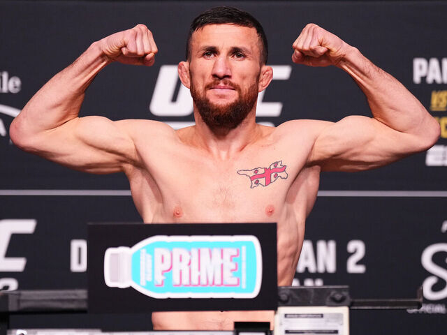 LAS VEGAS, NEVADA - DECEMBER 05: Merab Dvalishvili of Georgia poses on the scale during the UFC 323 official weigh-in at UFC Apex on December 05, 2025 in Las Vegas, Nevada.