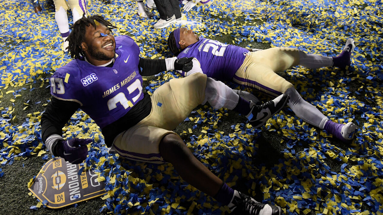 HARRISONBURG, VIRGINIA - DECEMBER 05: Mychal McMullin #93 and Jobi Malary #28 of the James Madison Dukes celebrate after the game against the Troy Trojans at Bridgeforth Stadium on December 05, 2025 in Harrisonburg, Virginia. The Dukes defeated the Trojans 31-14.