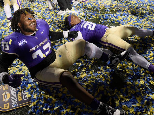 HARRISONBURG, VIRGINIA - DECEMBER 05: Mychal McMullin #93 and Jobi Malary #28 of the James Madison Dukes celebrate after the game against the Troy Trojans at Bridgeforth Stadium on December 05, 2025 in Harrisonburg, Virginia. The Dukes defeated the Trojans 31-14.