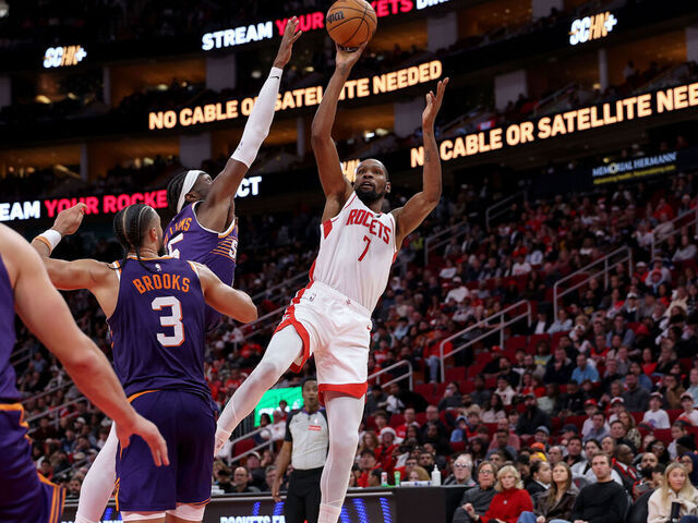 HOUSTON, TEXAS - DECEMBER 05: Kevin Durant #7 of the Houston Rockets shoots against Mark Williams #15 of the Phoenix Suns in the second half at Toyota Center on December 05, 2025 in Houston, Texas.