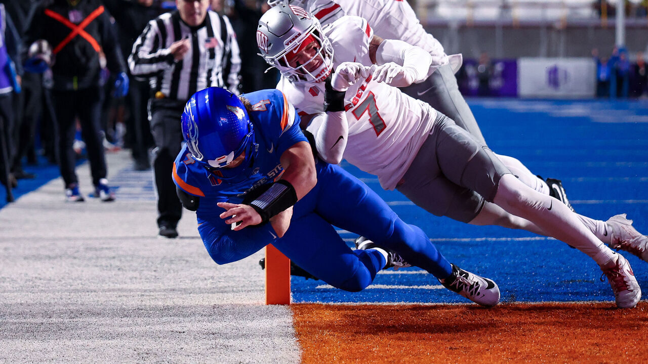 BOISE, IDAHO - DECEMBER 05: Maddux Madsen #4 of the Boise State Broncos dives for a touchdown against Jake Pope #7 of the UNLV Rebels at Albertsons Stadium on December 5, 2025 in Boise, Idaho.