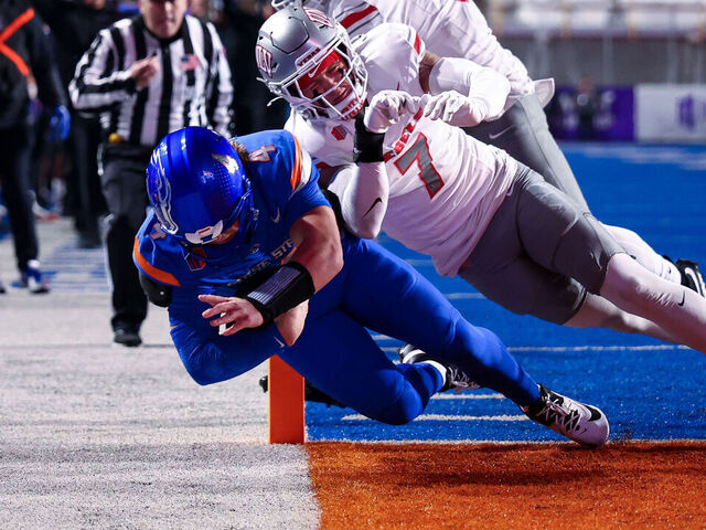 BOISE, IDAHO - DECEMBER 05: Maddux Madsen #4 of the Boise State Broncos dives for a touchdown against Jake Pope #7 of the UNLV Rebels at Albertsons Stadium on December 5, 2025 in Boise, Idaho.