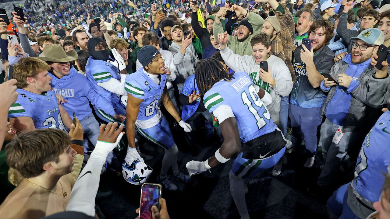NEW ORLEANS, LOUISIANA - DECEMBER 5: Tulane Green Wave players and fans celebrate on the field after the 34-21 win over the North Texas Mean Green during the 2025 American Conference Football Championship at Yulman Stadium on December 5, 2025 in New Orleans, Louisiana.