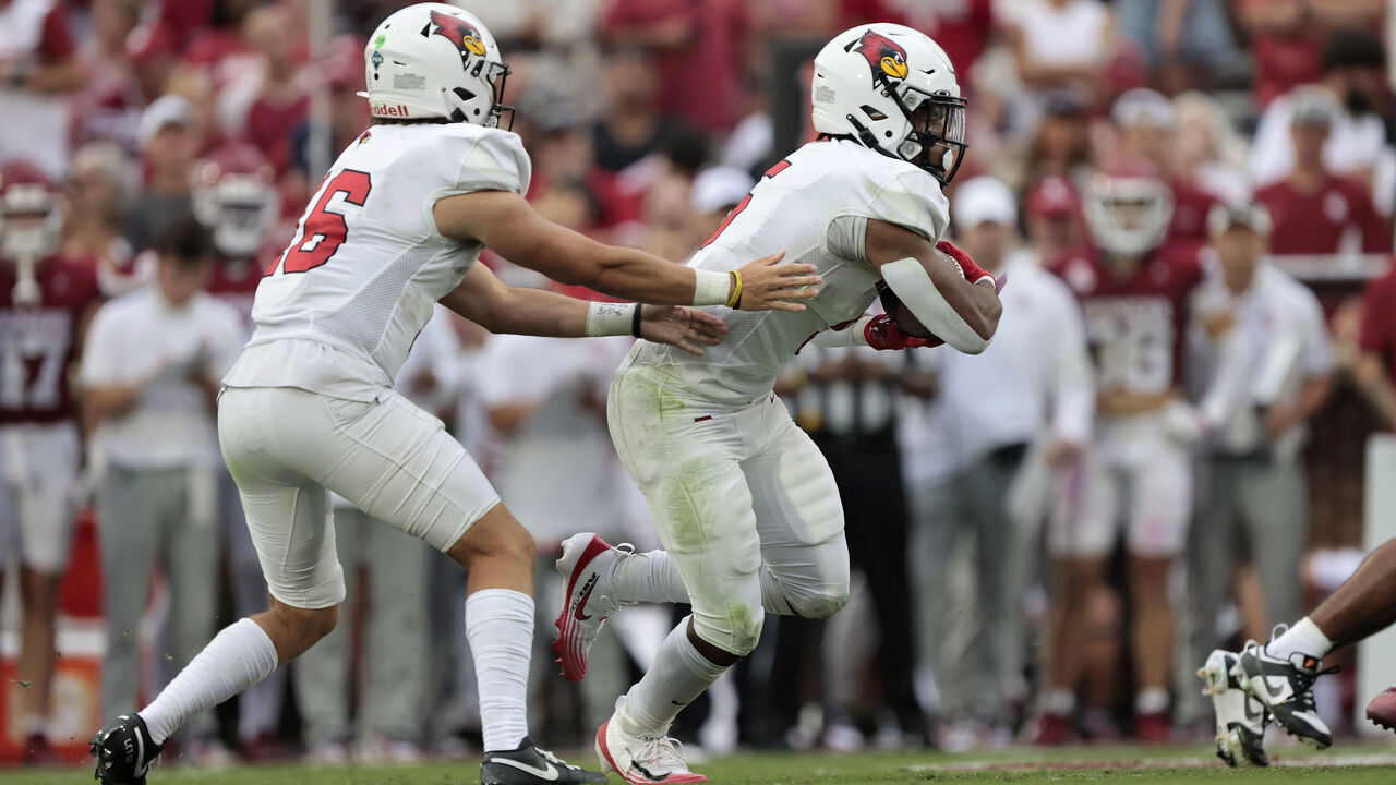 NORMAN, OKLAHOMA - AUGUST 30: Running back Victor Dawson #5 takes a handoff from quarterback Tommy Rittenhouse #16 of the Illinois State Redbirds against the Oklahoma Sooners near the end of the second quarter at Gaylord Family Oklahoma Memorial Stadium on August 30, 2025 in Norman, Oklahoma. Oklahoma won 35-3.