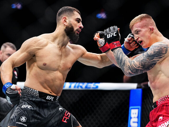 LAS VEGAS, NEVADA - DECEMBER 06: (L-R) Ibo Aslan of Turkey punches Iwo Baraniewski of Poland in a light heavyweight fight during the UFC 323 event at T-Mobile Arena on December 06, 2025 in Las Vegas, Nevada.